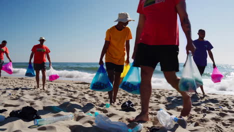 volunteers cleaning up plastic waste on a beach