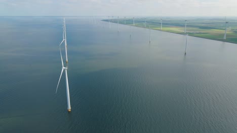 huge windmill turbines, offshore windmill farm in the ocean westermeerwind park , windmills isolated at sea on a beautiful bright day netherlands flevoland noordoostpolder