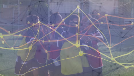 soccer teammates hugging on turf field, showing glowing sports technology data overlay and goal net