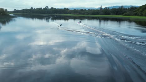 aerial tracking a slalom waterskier freeskiing behind boat