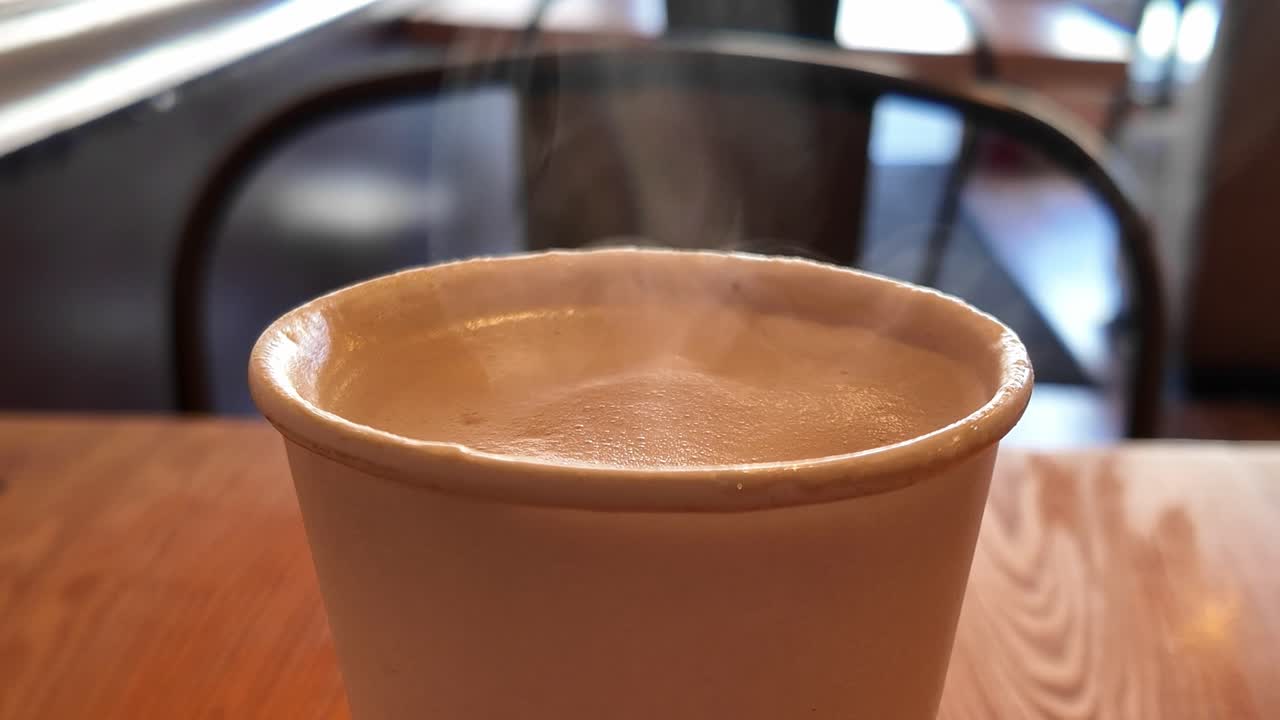 Close up of a handcrafted vanilla latte sits fresh on a wooden table, blending comfort and simplicity in a San Francisco café.