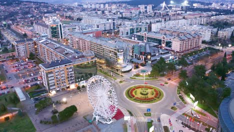 podgorica montenegro in the evening. night cityscape of the capital of a small country in the balkans, south east europe. traffic on roundabout in residential and commercial city center.