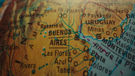 close-up of a world globe showing buenos aires, montevideo, and uruguay