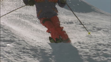 a person skies downhill with poles