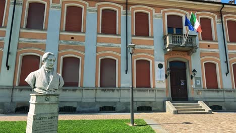 statue and flags outside historic italian building