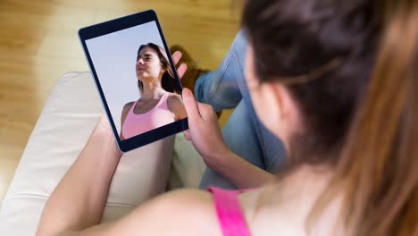 Tablet-screen-showing-woman-working-out-Video