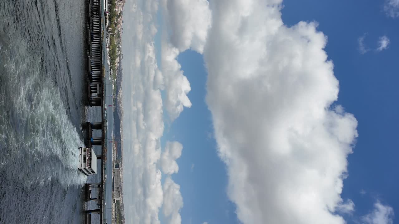 Boat on Water Under a Cloudy Sky with a Distant Shoreline