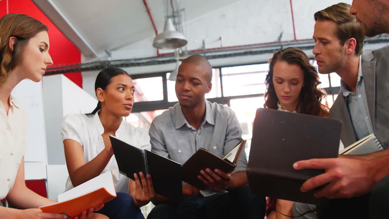 Business executives interacting with each other in meeting