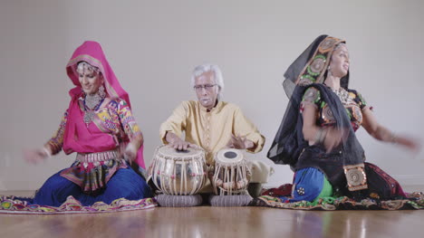 indian percussion musician with dancers 01