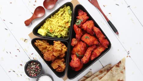 spicy indian fried chicken served with curry vegetable rice  onion bhajia  naan bread