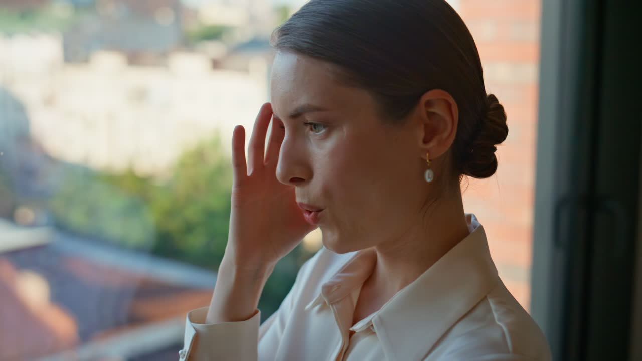 Annoyed woman finish call feeling stress gesturing emotionally in office closeup
