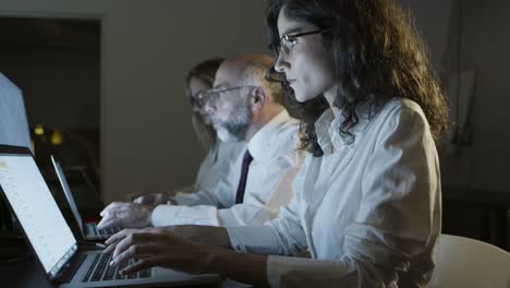 focused business people typing on laptops