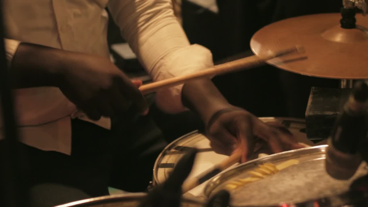 Black African Man playing drum kit in slow motion at a Party in Ghana