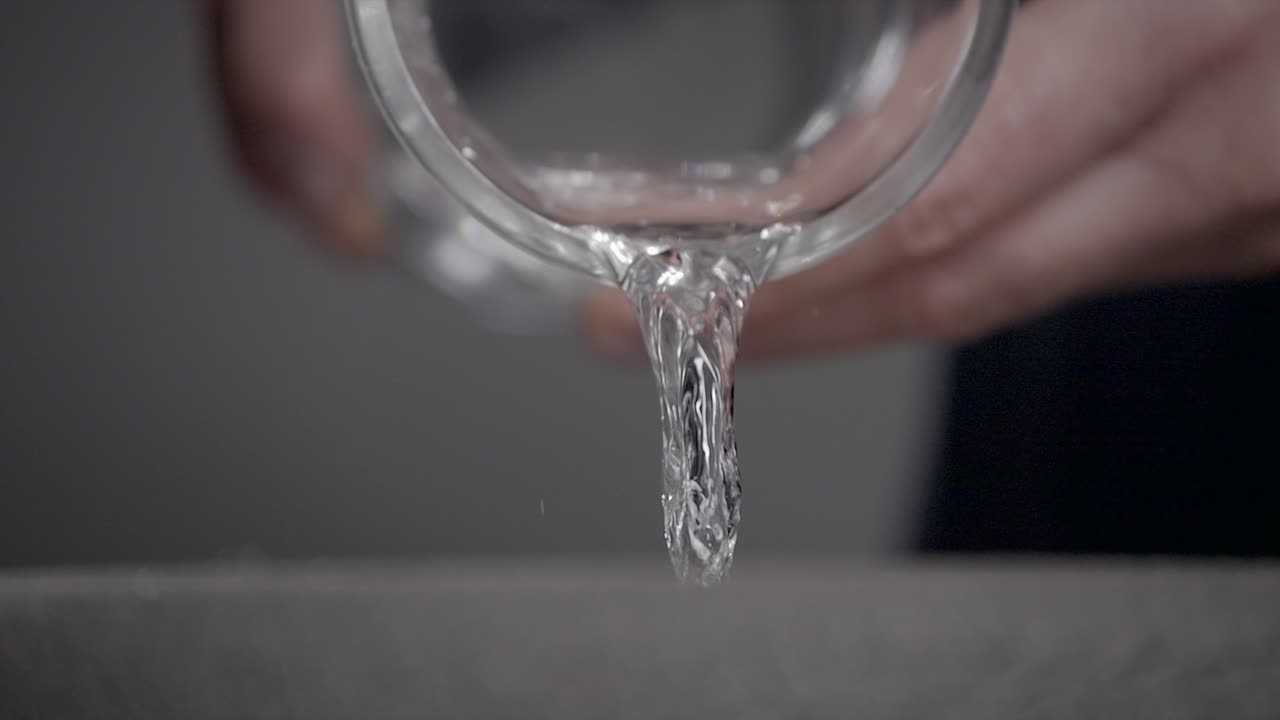 Slow Motion Shot Of Person Pouring Water From Glass