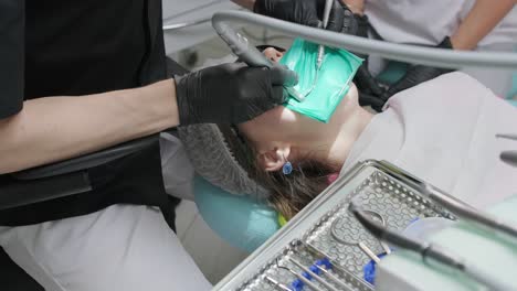 overview of dental caries prevention, girl at the dentist chair during a dental scaling procedure,