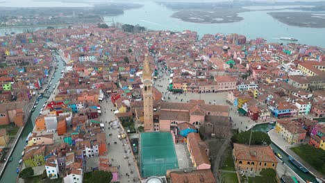 burano aerial wide with the church of saint martin bishop bell tower in burano, on a foggy day.