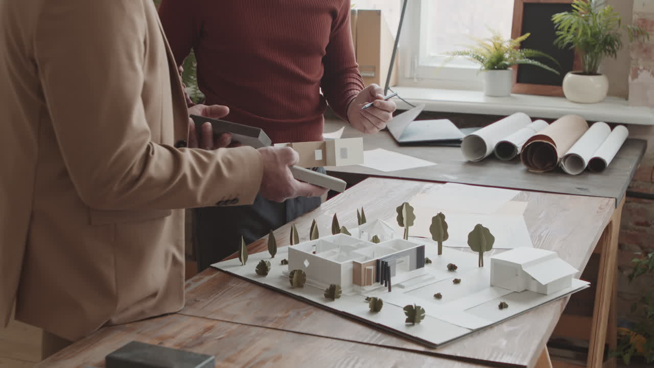 Male Architects Creating 3D Layout Of New House In Office