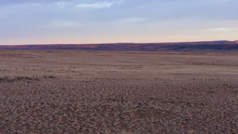 low-altitude flight over a western landscape in norwood, colorado with beautiful mountain in background