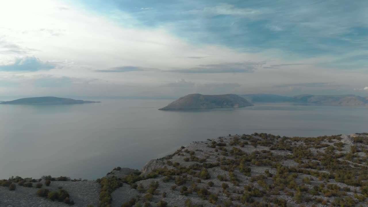 Aerial panning shot of rocky seashore and islands in cloudy day-1