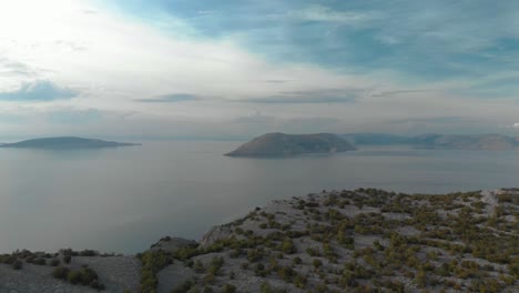 Aerial-panning-shot-of-rocky-seashore-and-islands-in-cloudy-day-1