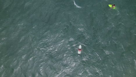 Top-view-of-a-drone-showing-surfers-waiting-for-waves