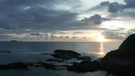 the vast south pacific ocean and the rocky island of kuata under the sunset