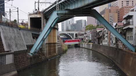 trains crossing kanda river from ochanomizu station, tokyo