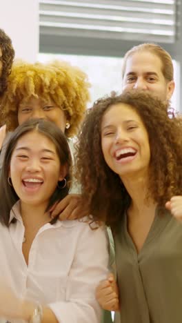 Coworkers celebrating raising fist and looking at camera