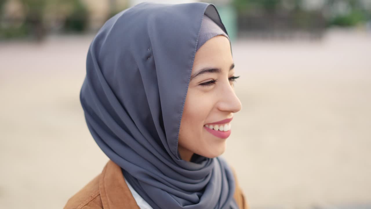 Close-up profile of a young Muslim woman wearing a hijab