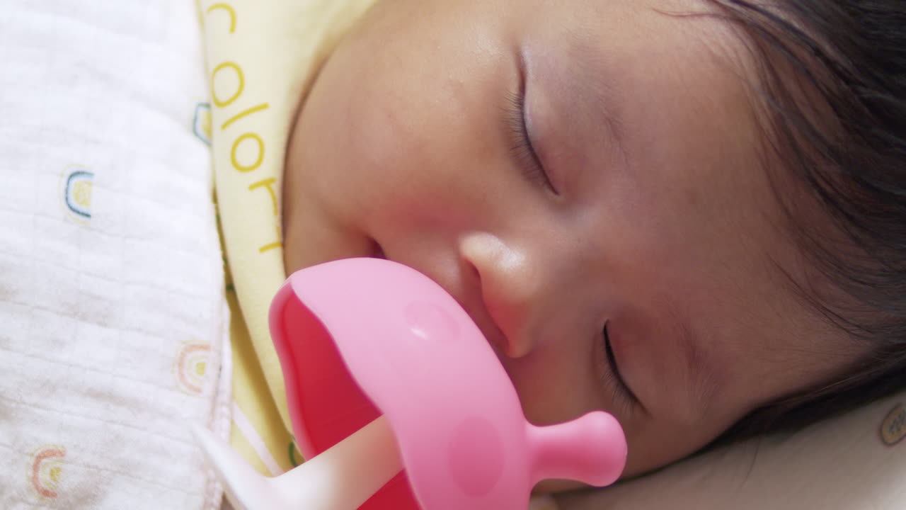 Adorable Baby Girl Sleeping Peacefully with Pacifier