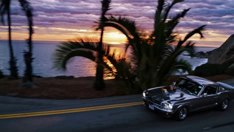 a vintage car speeds along a coastal road at sunset, captured in a dynamic side angle