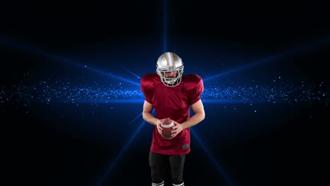 male rugby player throwing a ball against spot of light