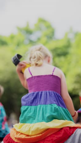 child wearing rainbow dress at a pride parade