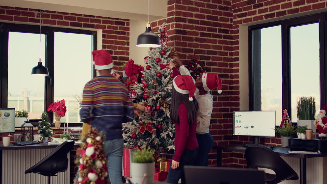 Multiethnic team of people putting christmas tree decor