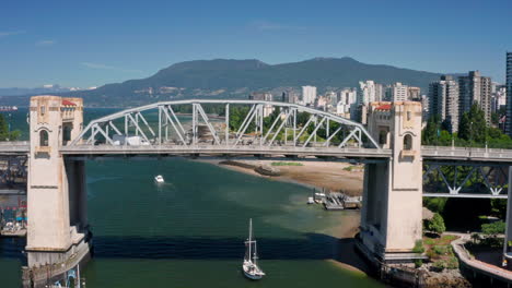 Sailboat-Sailing-At-False-Creek-Under-Burrard-Bridge---English-Bay-And-Downtown-Vancouver-In-Canada