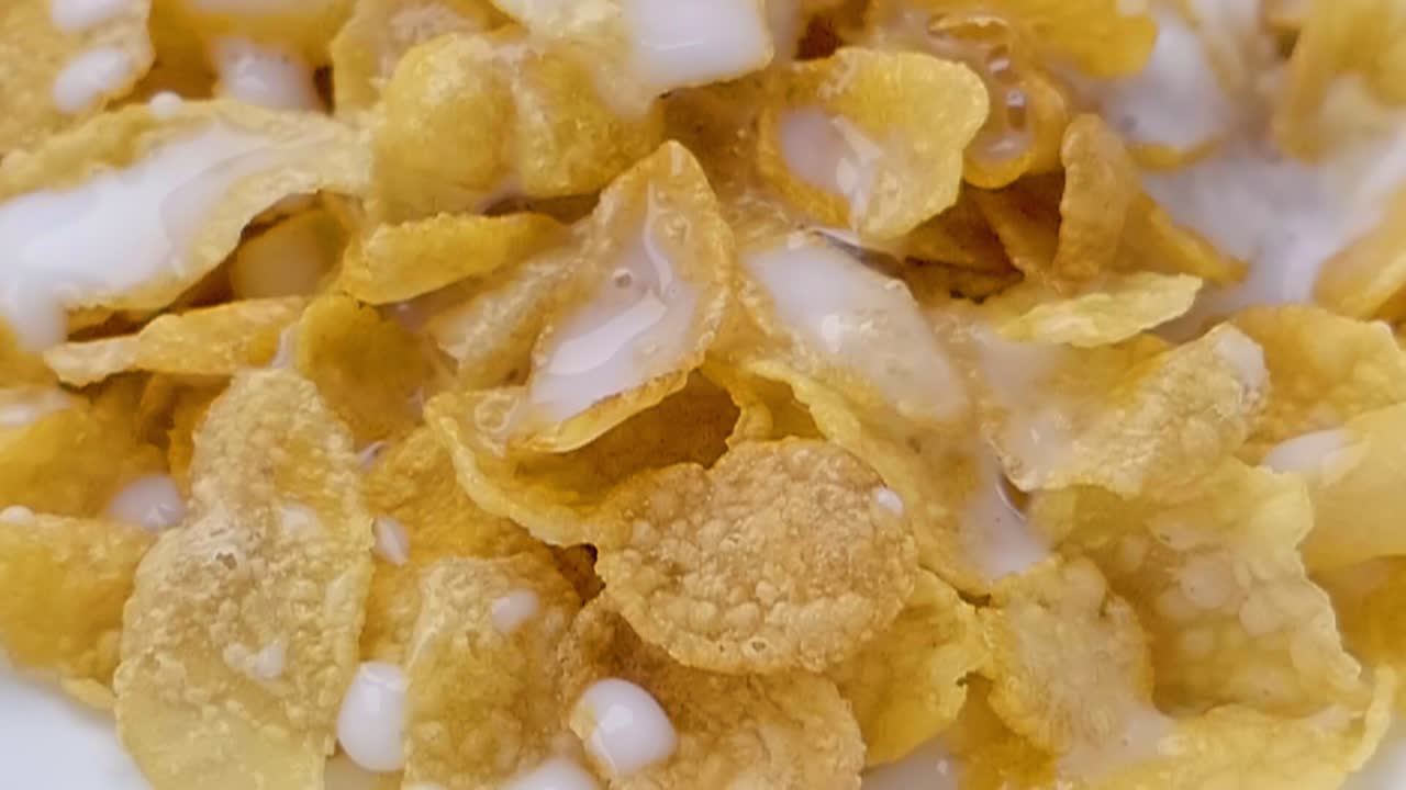 Slider Shot of Milk Being Poured onto Cereal in Slow Motion
