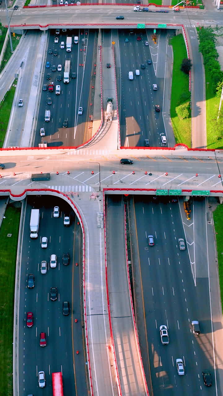 Expressway I-90 traffic entering downtown Chicago. Aerial view above traffic on Chicago freeway. Multilane road with bridges and cars. Vertical video