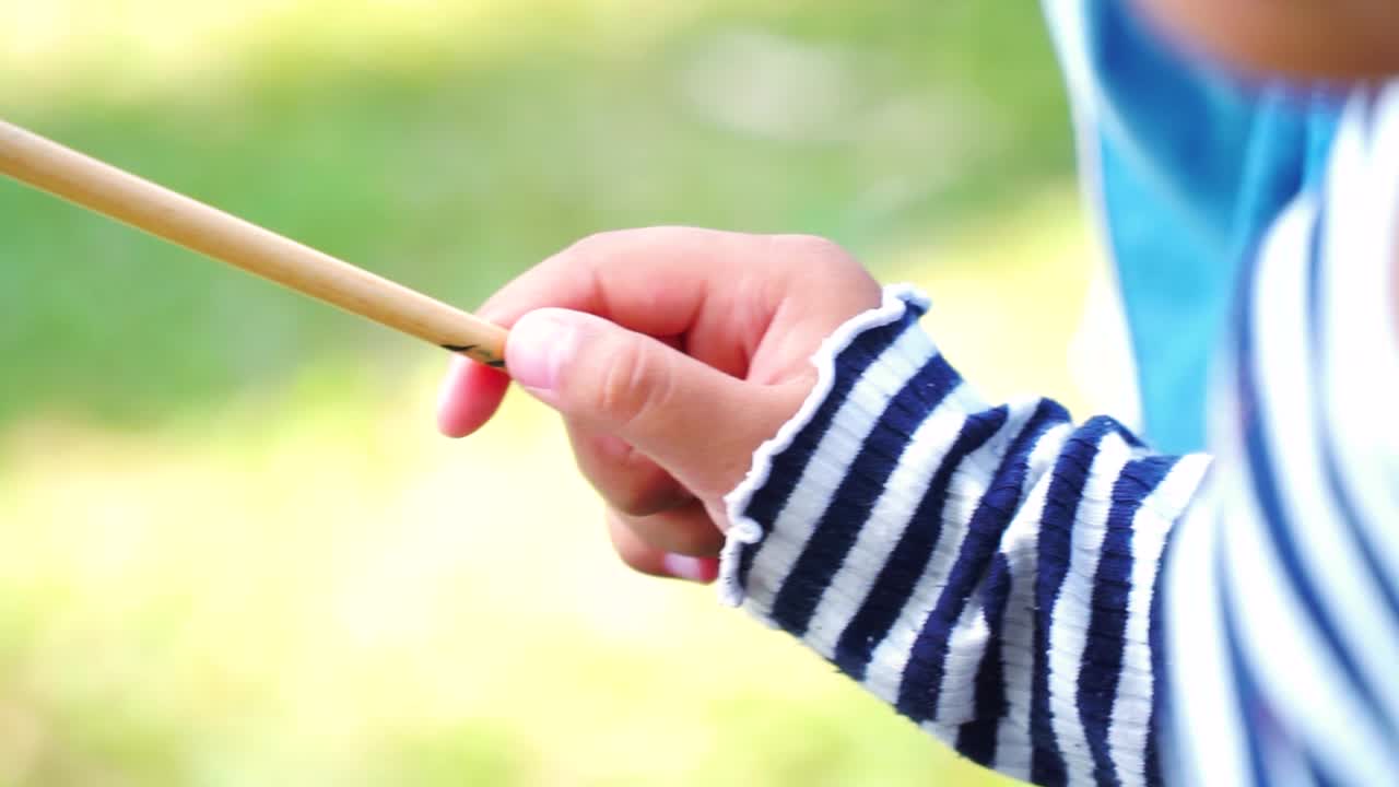 Little child's hand holding a painting brush