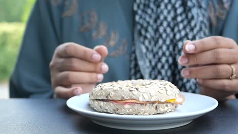 woman eating a bagel for breakfast