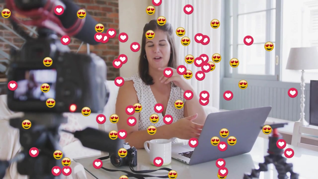 Female Vlogger Recording Video Content with Social Media Heart Emojis