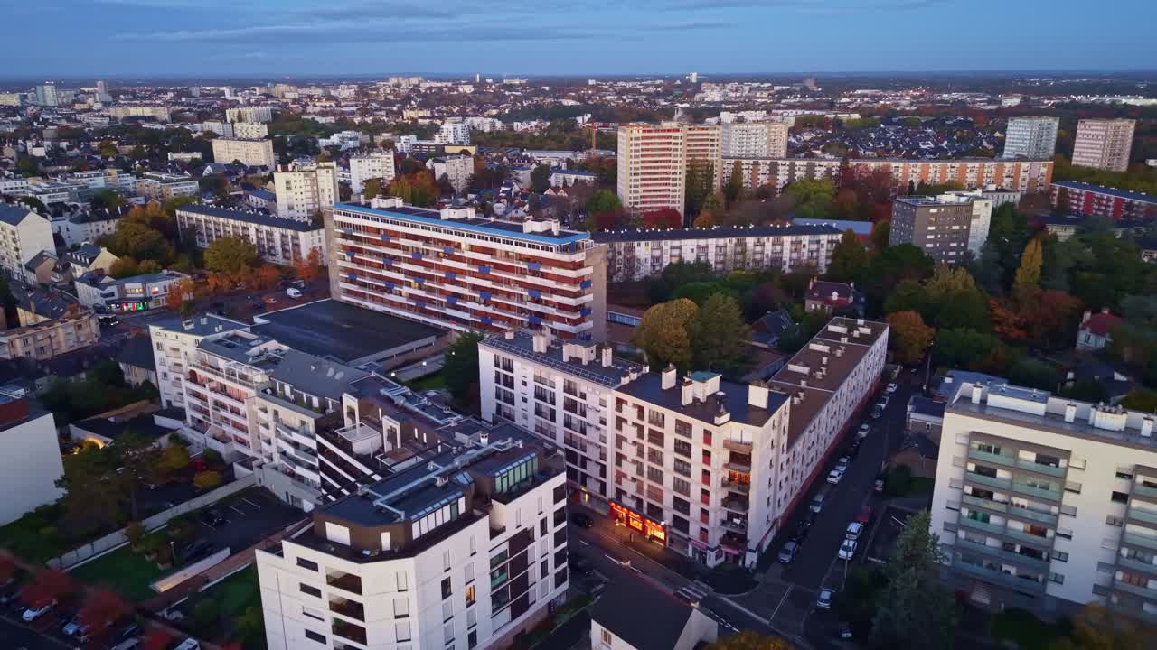 Drone fly over the densely populated Maurepas district residential buildings under late sunset light, Rennes, Brittany, France