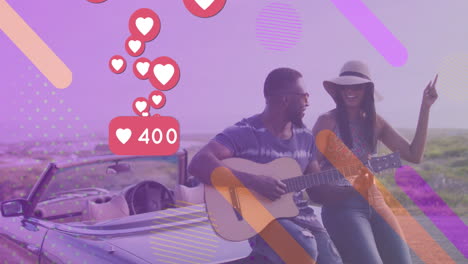 Animation-of-hearts-and-number-over-happy-diverse-couple-sitting-at-cabriolet-and-playing-guitar
