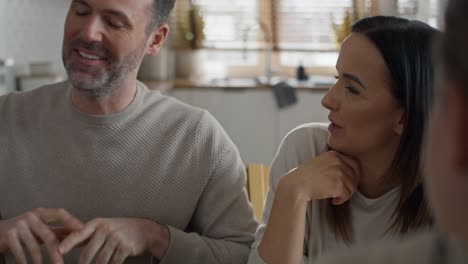 Caucasian-couple-talking-with-unrecognizable-woman-over-breakfast-together