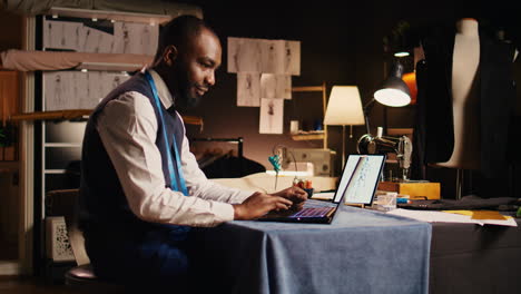 young fashion designer using laptop