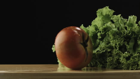 slow-motion of tomato hitting lettuce