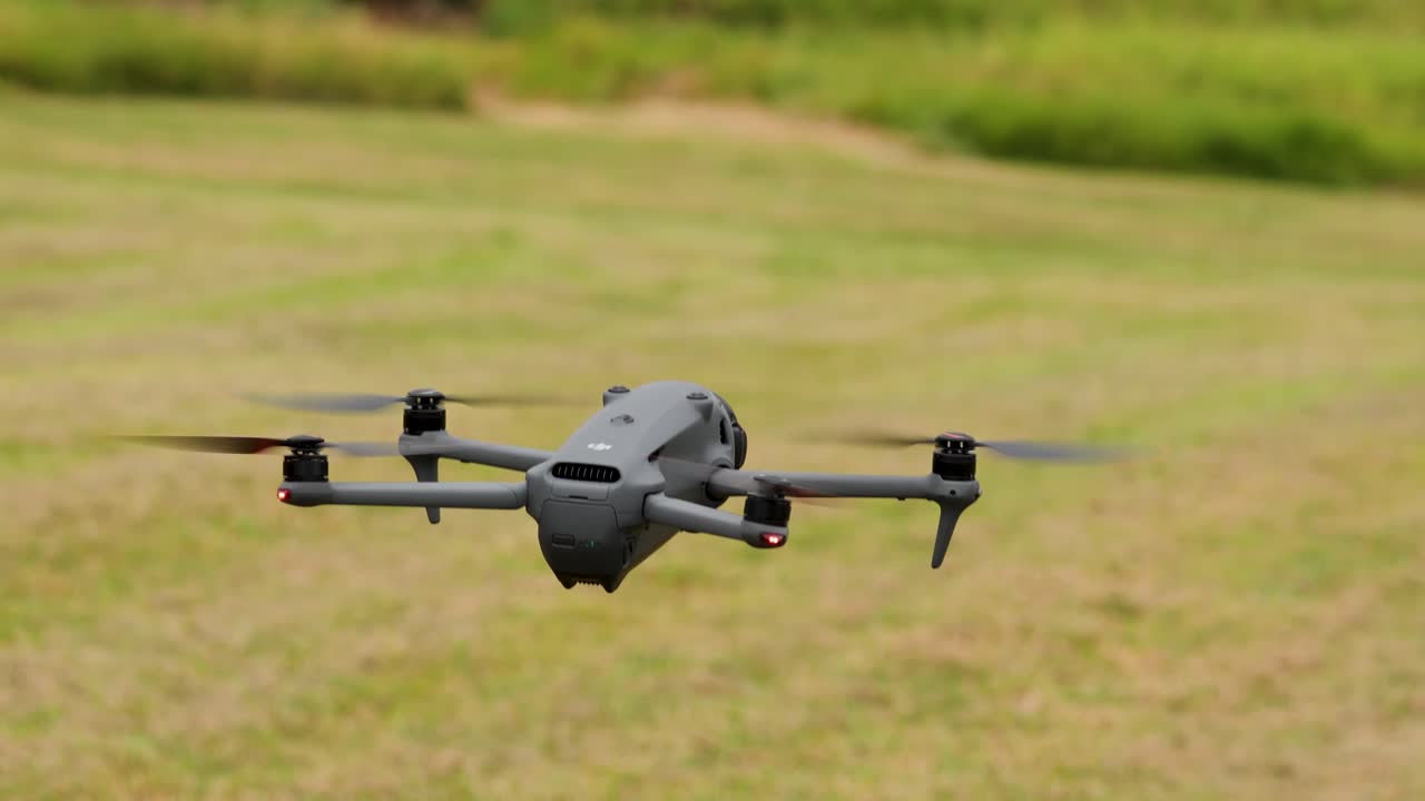 A drone ascends from a grassy field, captured in daylight with a steady camera, showcasing smooth take-off