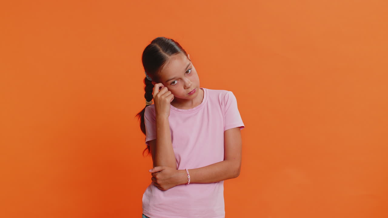 Thoughtful clever young preteen child girl kid pondering a solution doubting question brainstorming