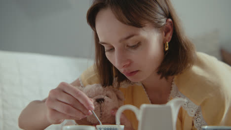 a girl playing with dolls in her room