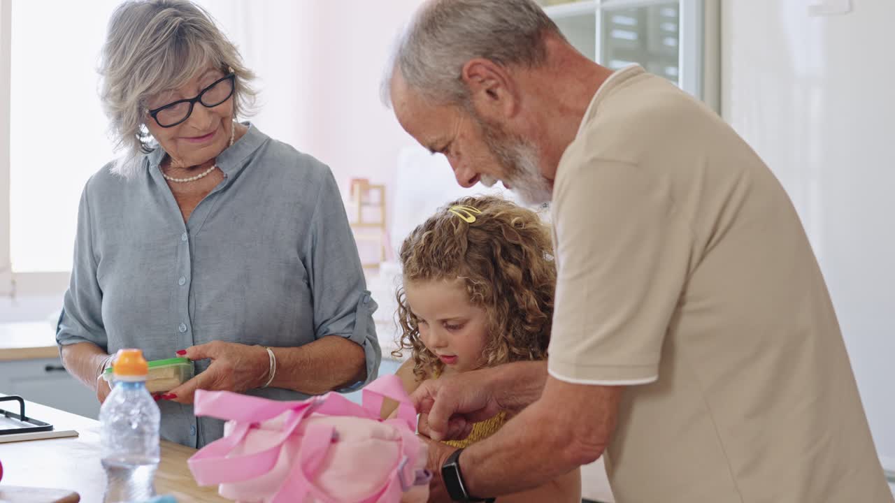 Grandparents packing lunch for their granddaughter