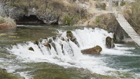 Huacaya-beautifull--waterfall-over-rocks-and-bridge-4k